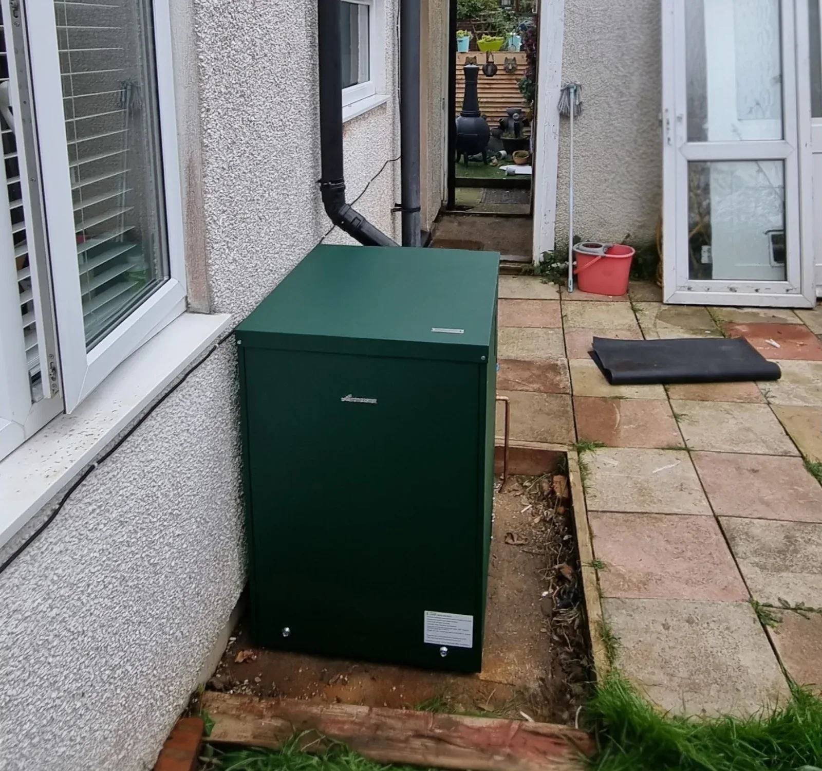 External oil boiler neatly installed in a side passage