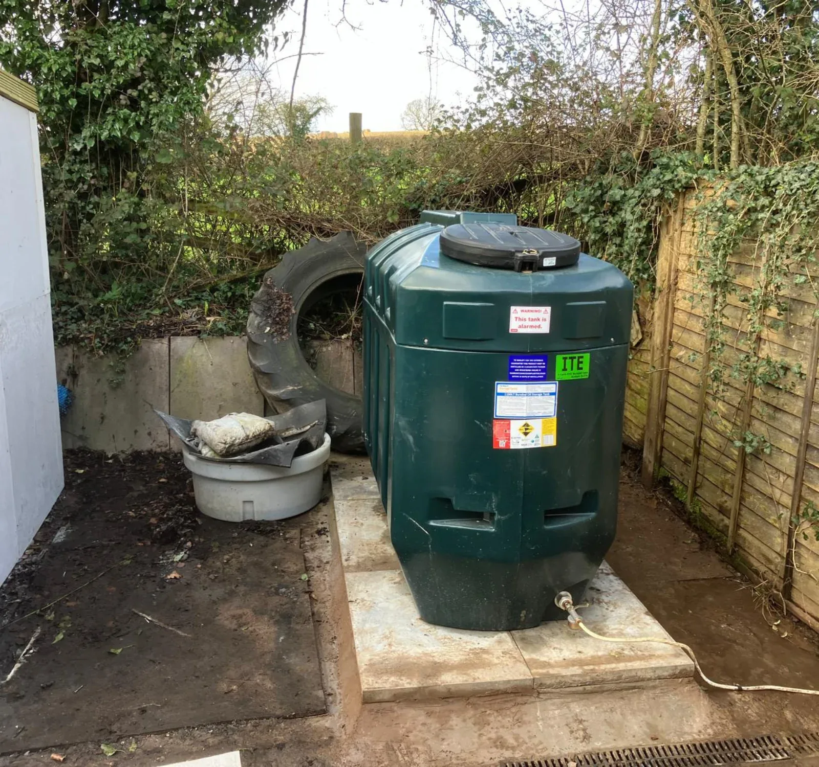 Bunded external oil storage tank supplying an oil boiler