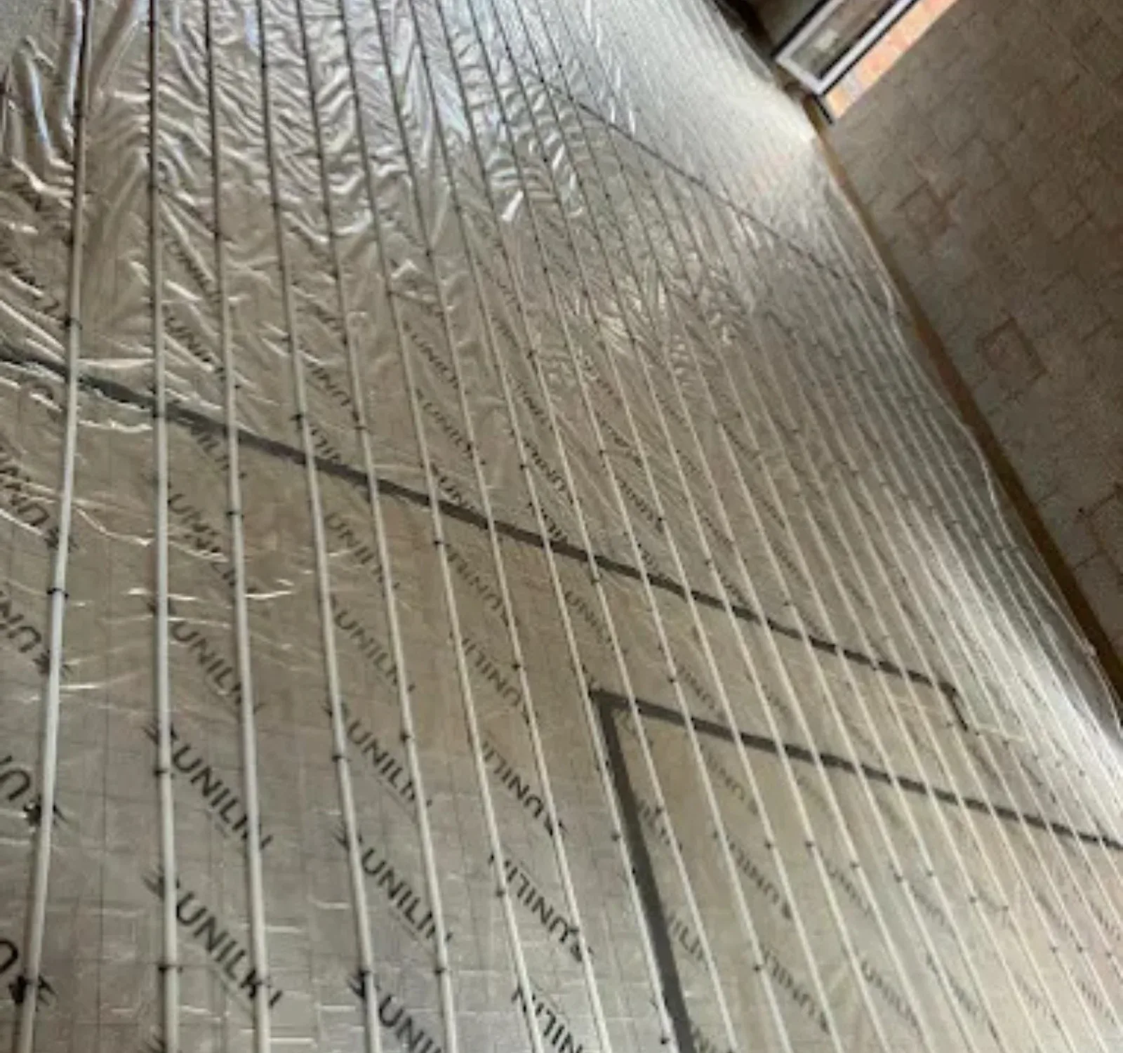 Underfloor heating pipework installed on insulation board